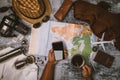 Tourist planning vacation with the help of world map and compass along and Coffee cup with coffee grinder with other travel