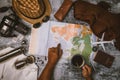 Tourist planning vacation with the help of world map and compass along and Coffee cup with coffee grinder with other travel