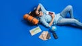 Tourist planning vacation with the help of world map with other travel accessories around. Woman traveler sleeping relax in hand