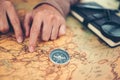 Tourist planning vacation, holiday with the help world map and compass. Man`s hand marks route on map and using pins and rope. Royalty Free Stock Photo