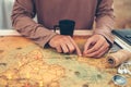 Tourist planning vacation, holiday with the help world map. Man`s hand marks route on map and using pins and rope Royalty Free Stock Photo