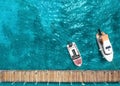 Tourist pleasure yacht and motor boat on the sea near the pier. Top view Royalty Free Stock Photo