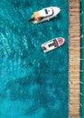 Tourist pleasure yacht and motor boat on the sea near the pier. Top view Royalty Free Stock Photo