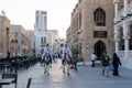 Doha, Qatar - Oct 17, 2022: Tourist police in traditional Qatari dress patrolling along the walkway in Souq Wakif.