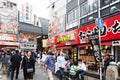 Tourist popular shopping scene in Osaka City at Dotonbori Namba area with signs and advertising billboards during daytime