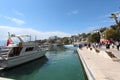 Tourist port in Antalya with boats. Old city. Sea view, ships and yachts. People walk along the promenade