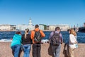 Tourist at the port of Neva River, looking at theh buildings at another side in St. Petersburg. Russia