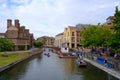 Tourist punting on the river Cam, viewed from Magdalene bridge with Magdalene College and Scudamore`s Quayside Punting Station in Royalty Free Stock Photo