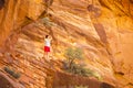 Tourist among red rocks in Zion National Park Royalty Free Stock Photo