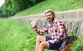 Tourist relaxing in park drink tea or coffee. Coffee on the go. man with a cup of coffee outdoors. Handsome calm bearded