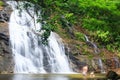 Tourist relaxing under flowing waterfall nature. Nature Therapy. Royalty Free Stock Photo