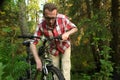 Tourist, repearing the bike in the woods