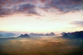 Tourist resort in Saxony. Fantastic dreamy sunrise on the top of the rocky mountain with the view into misty valley Royalty Free Stock Photo