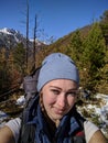 Tourists rest after hike and take selfie on the phone. Photos from the phone during the hike. Family travels. Woman