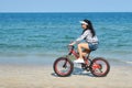 A tourist rides a Bicycle on the beach. sea Cycling. Asian athlete of the sea