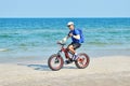 A tourist rides a Bicycle on the beach. sea Cycling. Asian athlete of the sea