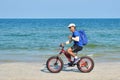 A tourist rides a Bicycle on the beach. sea Cycling. Asian athlete of the sea