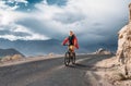 Tourist rides bike on road in Himalaya Mountain Royalty Free Stock Photo