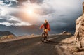 Tourist rides bike on road in Himalaya Mountain Royalty Free Stock Photo