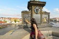 A tourist rubs the bronze plaque on the statue of Saint John of Nepomuk for good luck on the Charles Bridge in Prague Czechia