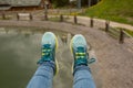 Tourist`s boots above the lake. Picture taken on a mountain lift Royalty Free Stock Photo