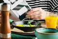 Tourist`s english Breakfast in cooking pan with fried eggs, sausages, bacon, toasts and coffee Royalty Free Stock Photo