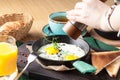 Tourist`s english Breakfast in cooking pan with fried eggs, sausages, bacon, toasts and coffee Royalty Free Stock Photo