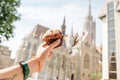 hand holds a fast food dessert on the background of the main sight of Budapest - Matthias Cathedral Royalty Free Stock Photo