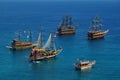 Tourist sailboats in turquoise waters of the Mediterranean sea beside the Turkish ancient fortress Alanya. Antalya Royalty Free Stock Photo