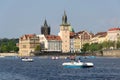 Tourist sailing on pedal boats on Vltava river near Charles bridge in Prague, Czech Republic