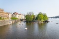 Tourist sailing on pedal boats on Vltava river near Charles bridge in Prague, Czech Republic