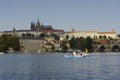 Tourist sailing on Vltava river with prague castle and touristic buildings at background