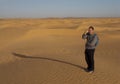 Tourist on sand dunes, Tunisia Royalty Free Stock Photo