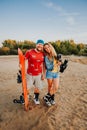 Tourist Sandboarding in the Desert a Man and a woman shoot a movie with a professional camera