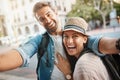 Tourist selfie, happy couple and outdoor for travel on a city street for happiness and holiday memory. Face of a man and Royalty Free Stock Photo