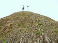 Tourist on sharp basalt peak of volcano formation Royalty Free Stock Photo