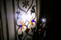 Tourist shining light on pietra dura stone inlay inside Taj Mahal, Agra, Uttar Pradesh, India