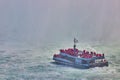 Tourist ship sailing into heavy mist at Niagara Falls Royalty Free Stock Photo