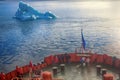 Tourist ship sails close to small iceberg