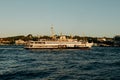 Tourist ship sails on the Golden Horn, scenic sunny beautiful waterfront of Istanbul city at sunset in summer