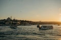 Tourist ship sails on the Golden Horn, scenic sunny beautiful waterfront of Istanbul city at sunset in summer