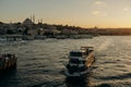 Tourist ship sails on the Golden Horn, scenic sunny beautiful waterfront of Istanbul city at sunset in summer