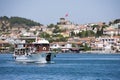 A tourist ship with stone windmill in Ayvalik, Turkey