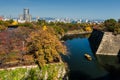 Torist boat at Osaka castle with autumn trees