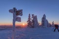 Tourist signpost mountain top Luzny covered by large ice. View of the snowy mountain peaks, view from Lusen in Bavaria in the morn Royalty Free Stock Photo