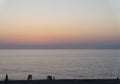 Tourist silhouette walking on the beach with orange and pink sunset landscape Royalty Free Stock Photo