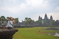 Tourist sit on big stone to photograph the Preah Vihear Temple