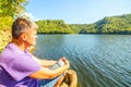 A tourist sits on the bank of the Yumaguzinsky reservoir Royalty Free Stock Photo