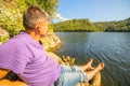 A tourist sits on the bank of the Yumaguzinsky reservoir Royalty Free Stock Photo