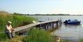 Tourist sits at a jetty